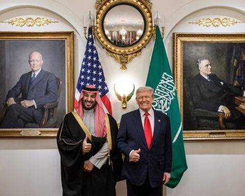 Trump and MBS pose for a portrait in the White House Cabinet Room with US and Saudi flags, November 2025