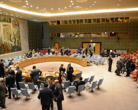UN Security Council chamber during a vote, with delegates gathered around the iconic circular table in New York