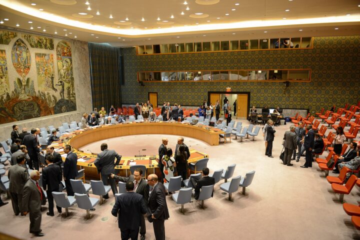 UN Security Council chamber during a vote, with delegates gathered around the iconic circular table in New York