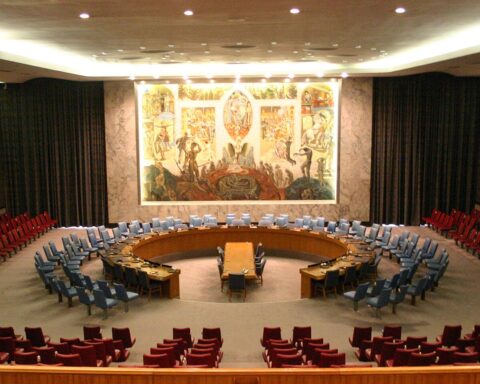 The UN Security Council chamber in New York showing the iconic horseshoe table and delegate seating, site of the April 7, 2026 Hormuz resolution veto by Russia and China