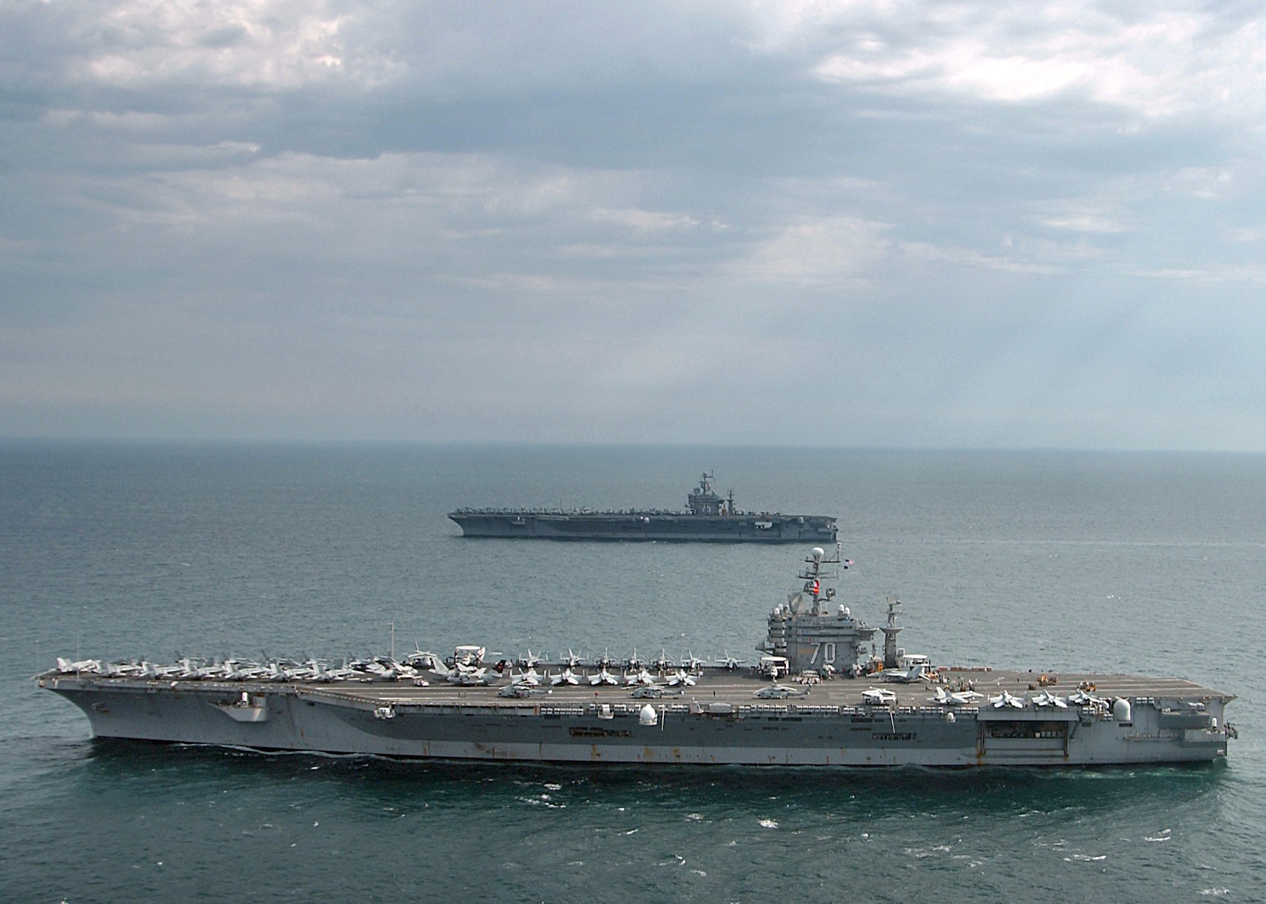 USS Carl Vinson and USS Harry S Truman aircraft carriers operating in the Persian Gulf representing US Fifth Fleet presence enforcing the April 2026 maritime blockade