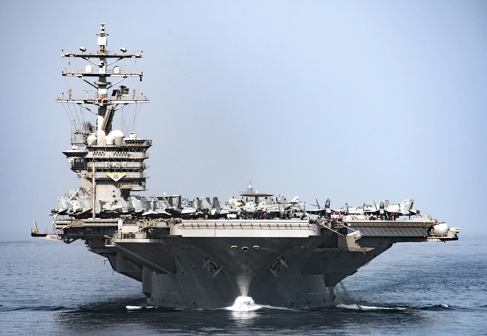 USS Eisenhower CVN-69 aircraft carrier transiting Strait of Hormuz with flight deck aircraft visible