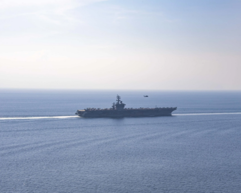 USS Dwight D. Eisenhower aircraft carrier transiting the Strait of Hormuz, November 2023. The US naval blockade has applied to Iranian ports since April 13, 2026.