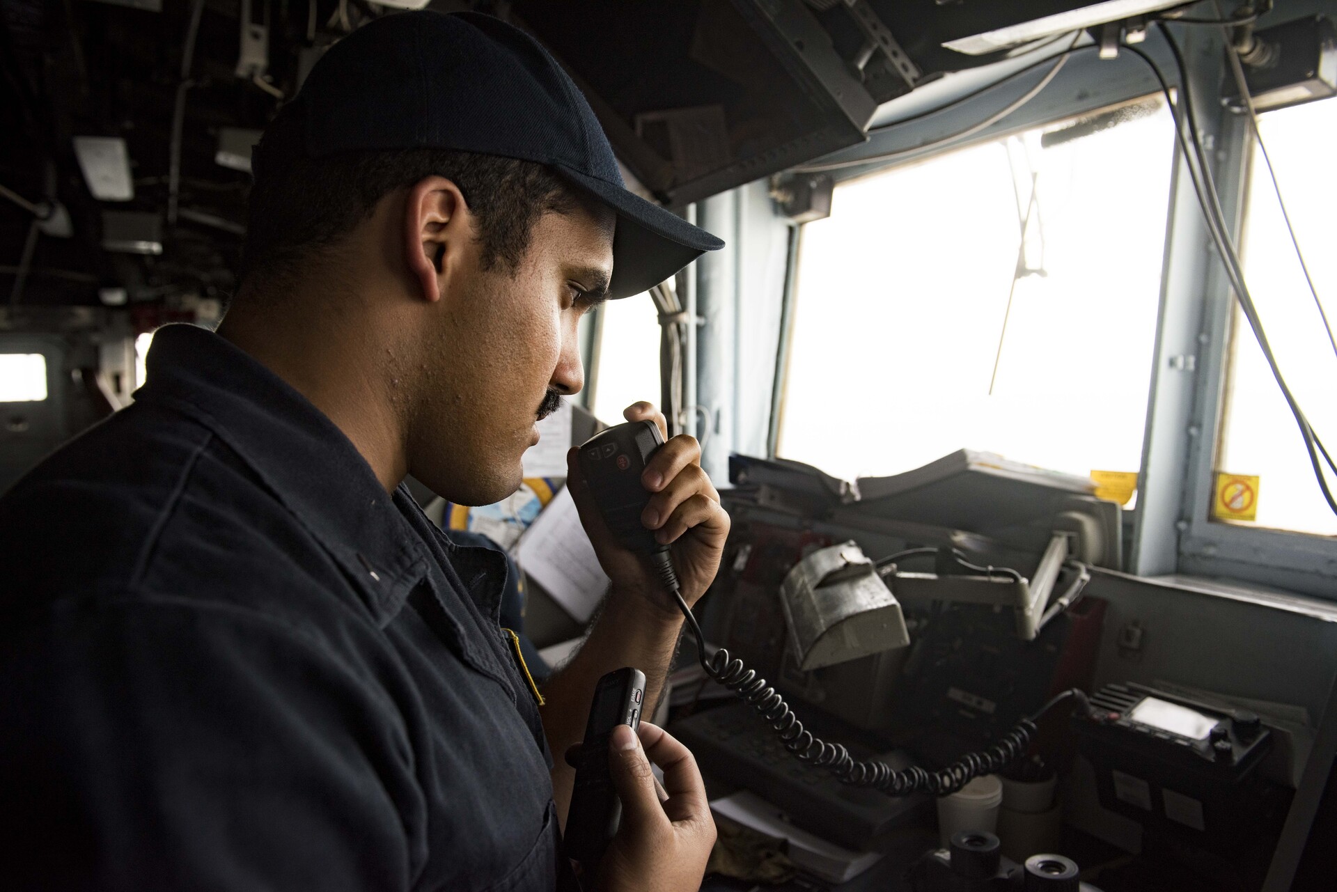 US Navy officer aboard USS San Jacinto communicates with Iranian warship during transit of the Strait of Hormuz July 2016