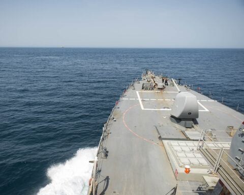 USS Stout (DDG 55) forward deck view transiting the Strait of Hormuz, June 2016, with a tanker visible in the distance