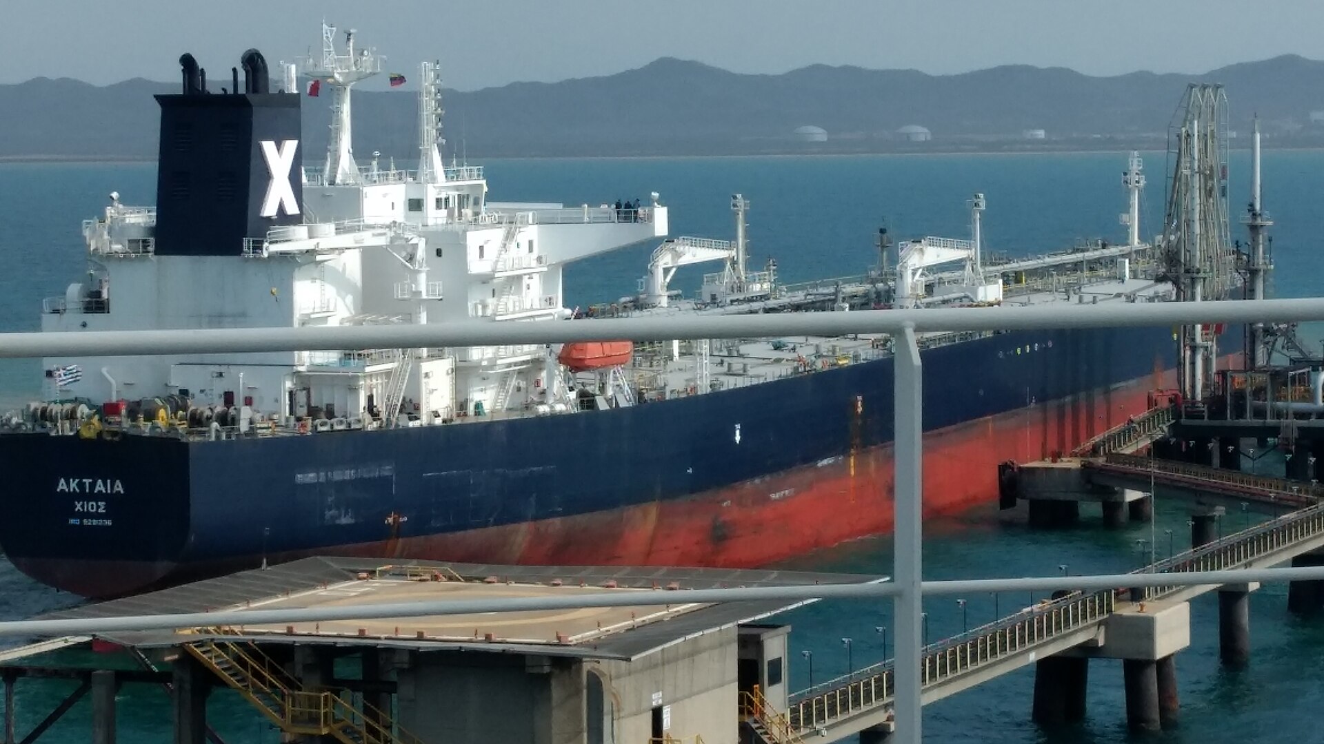VLCC supertanker Aktaia at a crude oil loading terminal, showing the scale of vessels transiting the Strait of Hormuz and subject to IRGC Persian Gulf Security Authority tolling