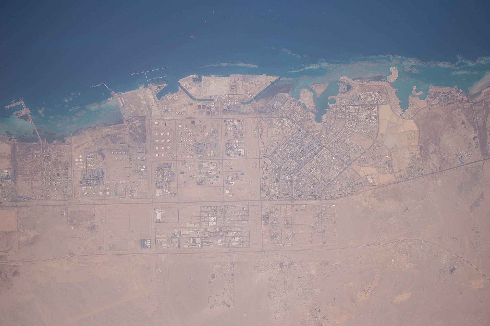 Yanbu Industrial City, Saudi Arabia — ISS satellite view showing oil storage tanks, processing facilities, and Red Sea loading terminal