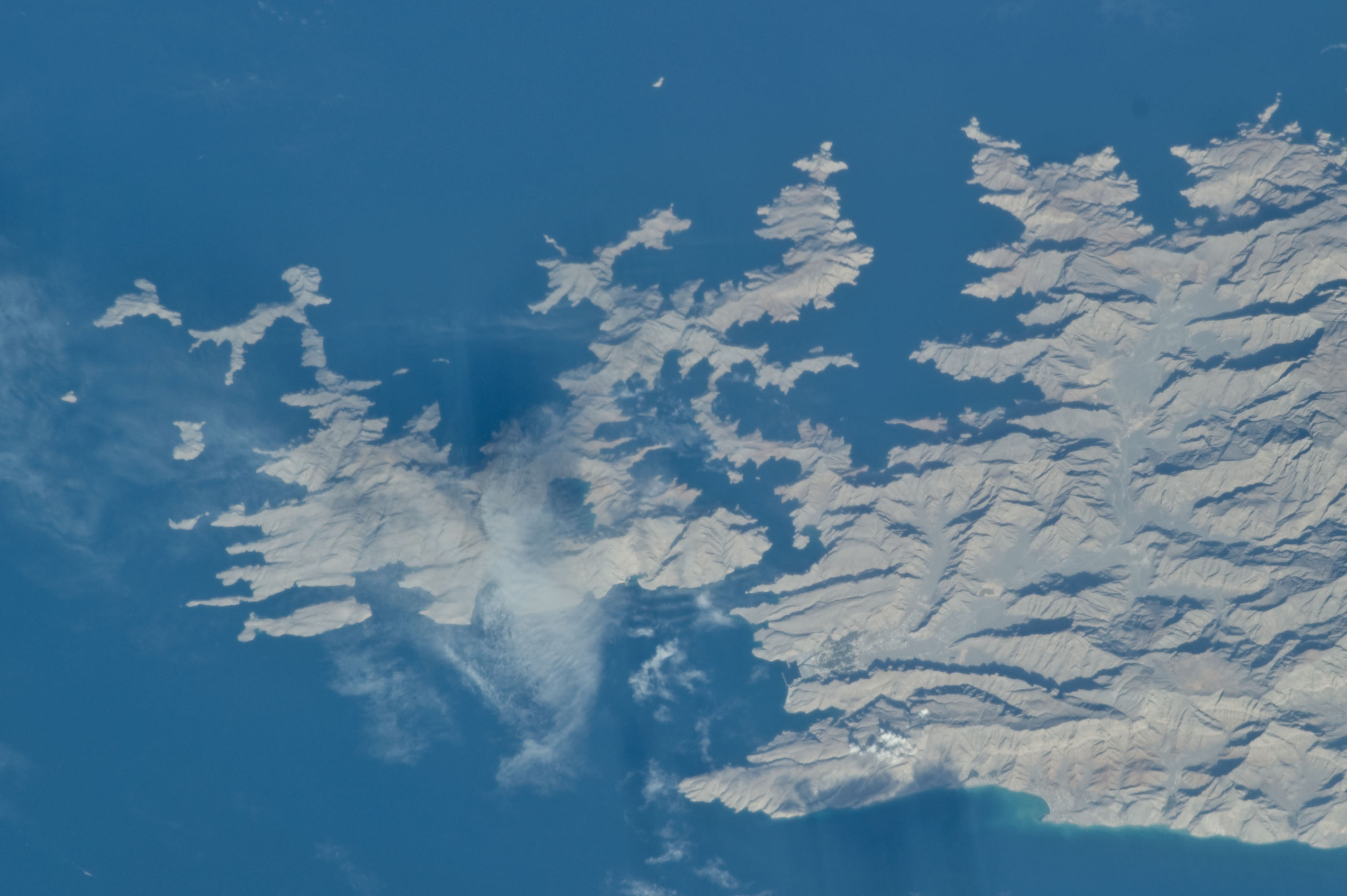 Musandam Peninsula, Oman exclave at the southern shore of the Strait of Hormuz, showing Khasab and the fjord-like khors that make the peninsula strategically critical to any Hormuz corridor