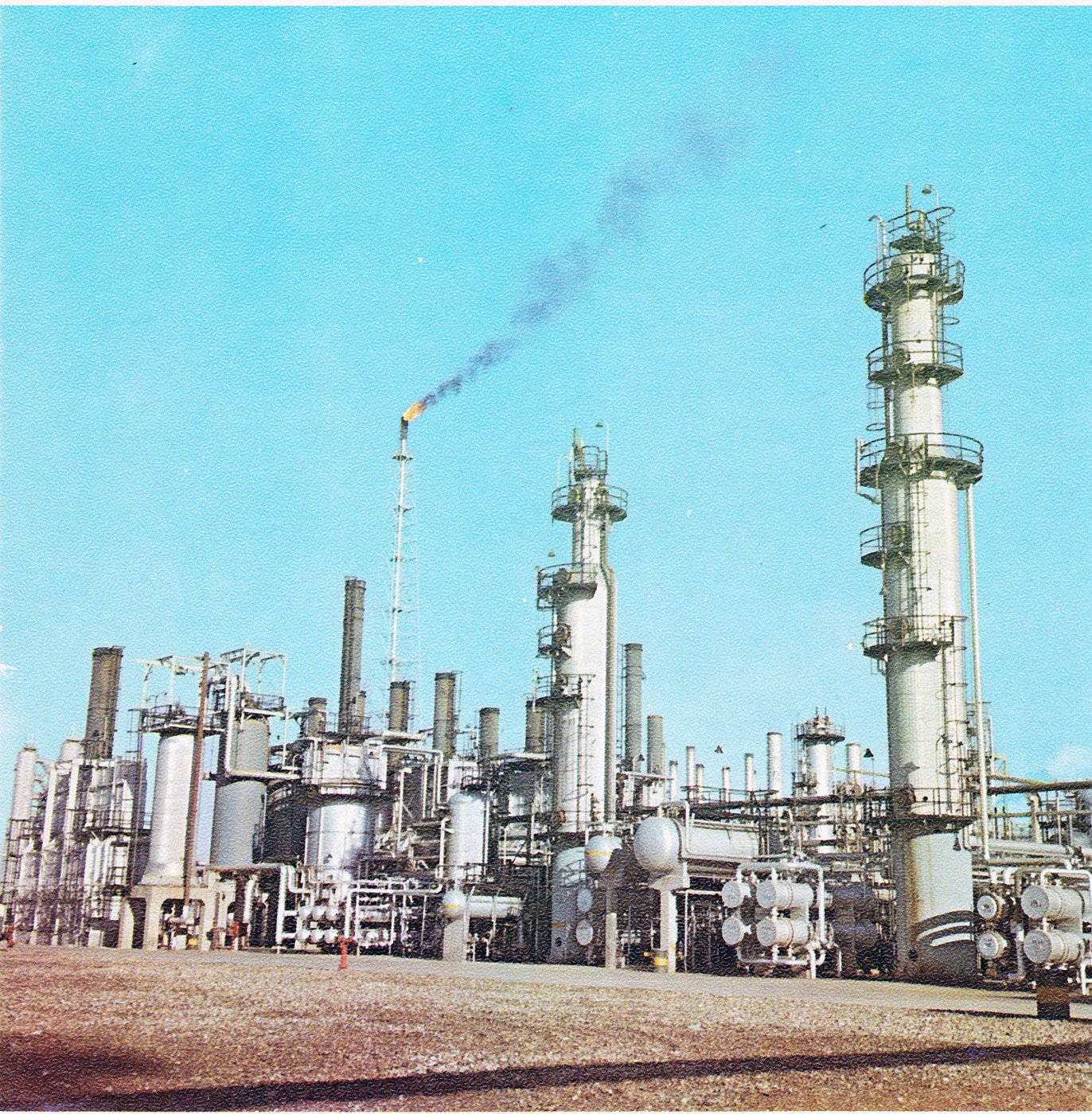 Abadan oil refinery catalytic facilities, Khuzestan Province, Iran — same province as Mahshahr PETZONE. Distillation columns and gas flare visible.