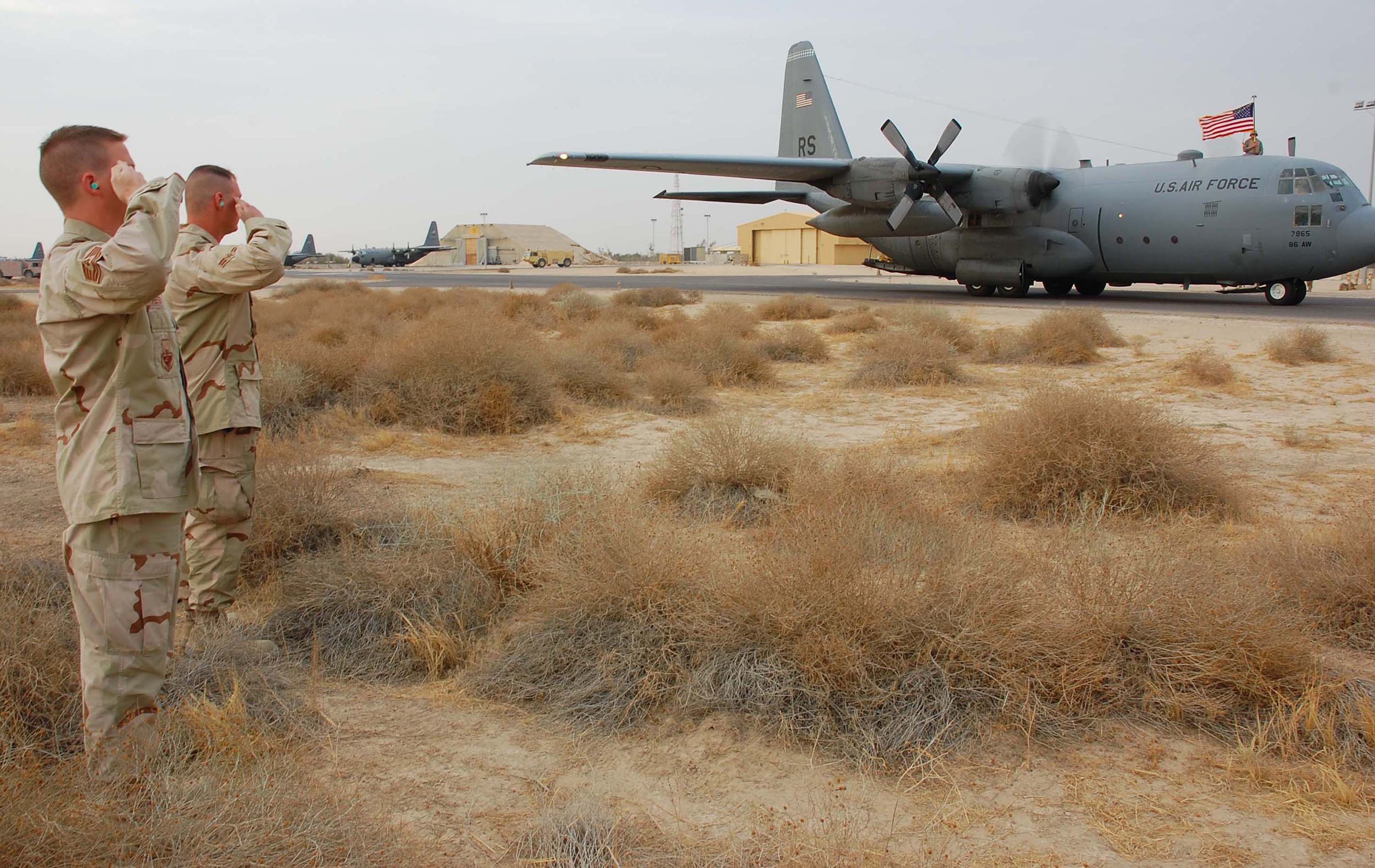US Air Force Airmen salute a C-130 Hercules at Ali Al Salem Air Base, Kuwait — the 386th Air Expeditionary Wing operates the base where Anduril counter-drone systems will be installed and tested against IRGC threats