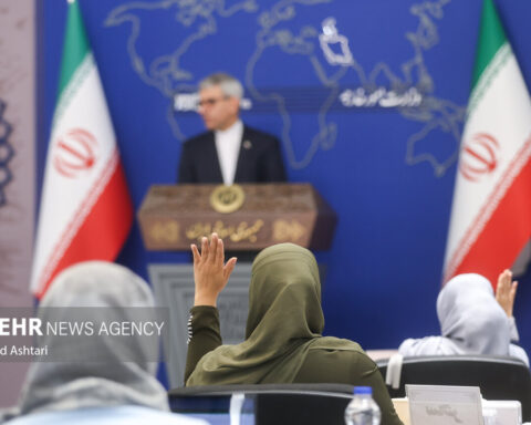 Esmaeil Baghaei, Iran Foreign Ministry spokesperson, at the weekly press conference podium in Tehran, flanked by Iranian flags and the Foreign Ministry world map backdrop