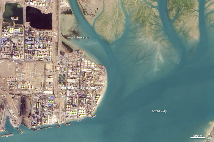 NASA satellite image of the Bandar Imam Khomeini petrochemical complex at Mahshahr, labeled 'petrochemical complex' on Musa Bay, Khuzestan Province, Iran.