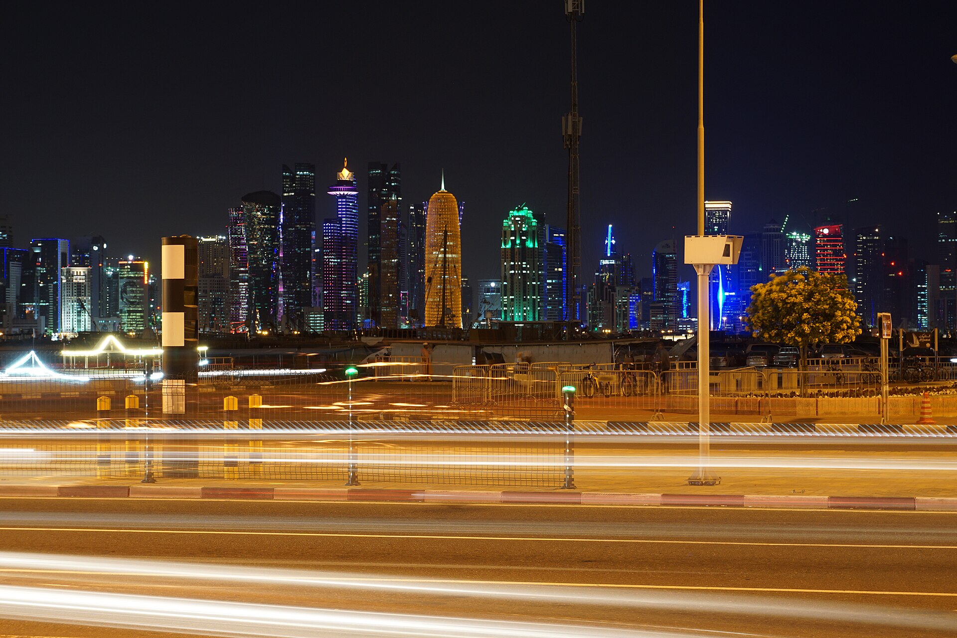 The West Bay district of Doha, Qatar, seen from the Al Corniche at night — Doha's status as the only functioning Gulf diplomatic relay channel between Riyadh and Tehran makes the Qatar capital central to the region's wartime diplomacy