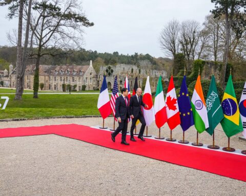 Secretary Rubio greeted by French Foreign Minister Barrot at G7 Foreign Ministers meeting Abbaye des Vaux-de-Cernay March 2026, with Saudi Arabian flag visible among G7-plus delegation banners
