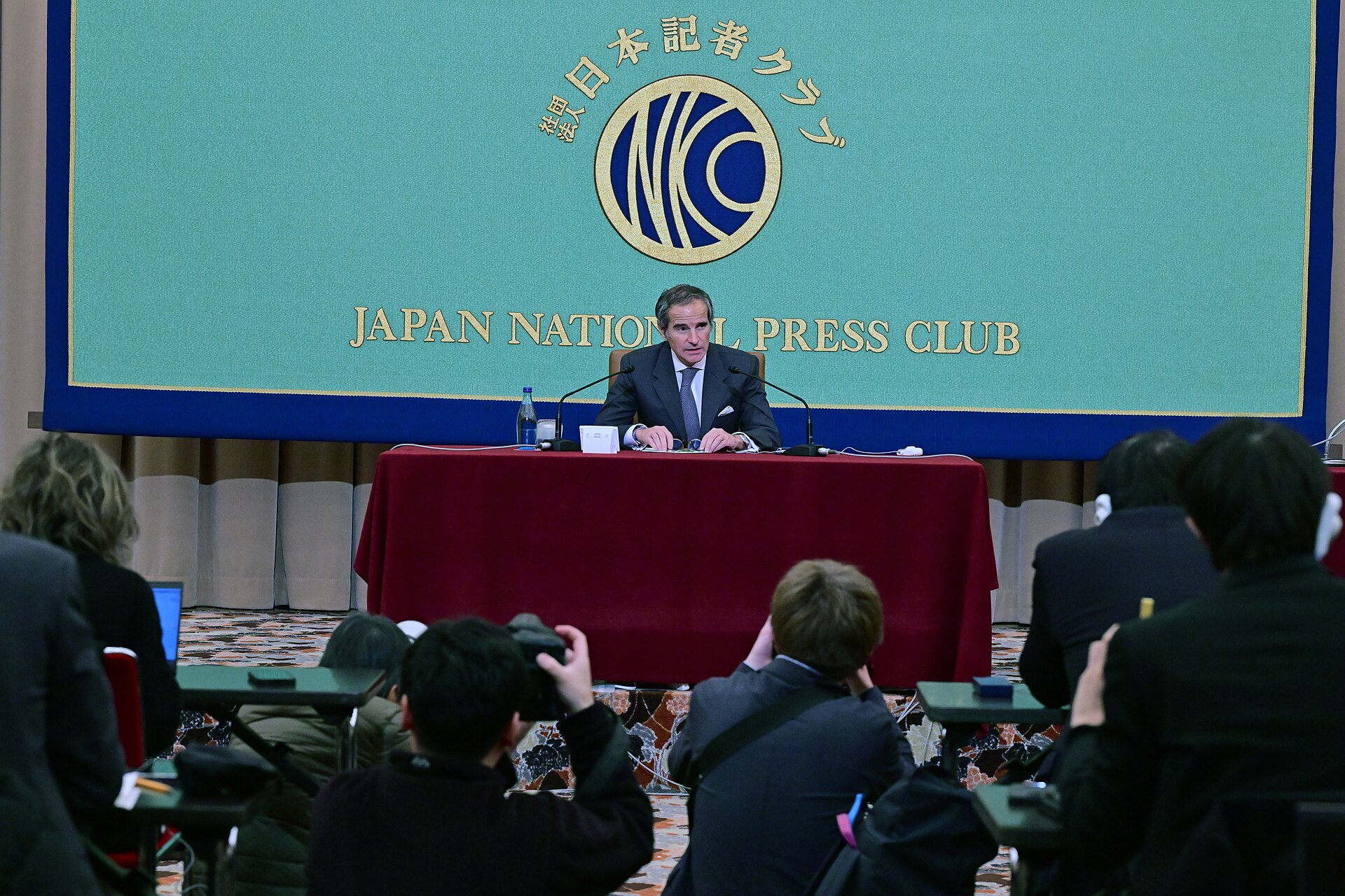 IAEA Director General Rafael Grossi addresses reporters at the Japan National Press Club in Tokyo, February 2025, with the JNPC banner and assembled press corps visible