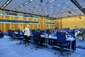 IAEA Board of Governors plenary session in Vienna, delegates seated at the circular arrangement in the M-Building conference hall