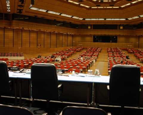 IAEA plenary hall at Austria Center Vienna, empty delegate seats before a General Conference session