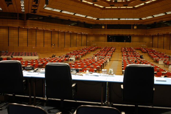IAEA plenary hall at Austria Center Vienna, empty delegate seats before a General Conference session