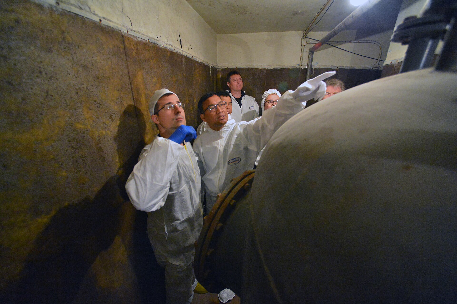 IAEA nuclear safeguards inspectors in protective gear conducting training inspection at a hot cell facility, Georgia