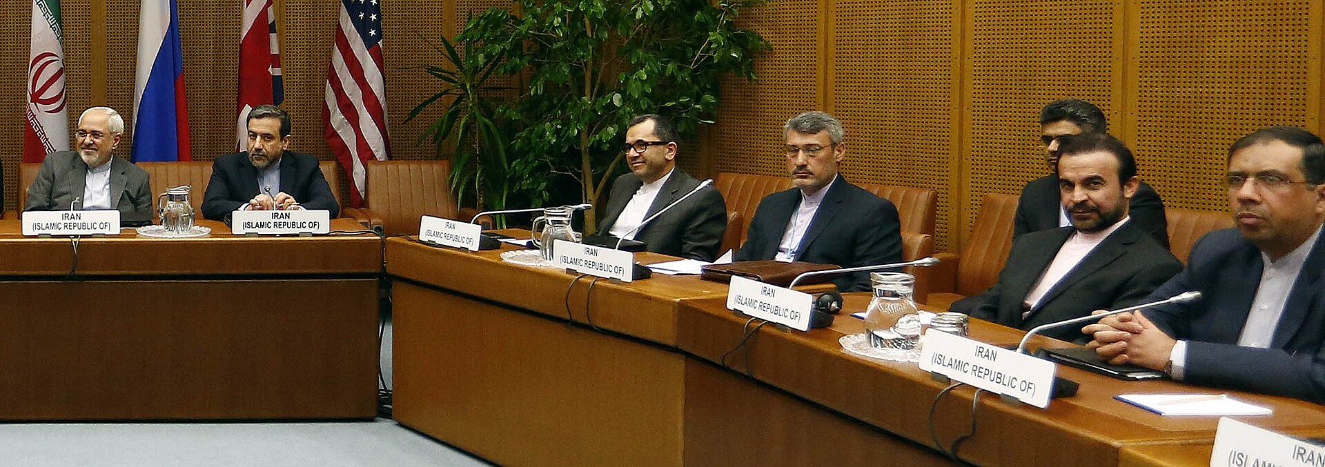 Iranian nuclear negotiating team including Zarif and Araghchi seated at the Vienna talks table in 2014 — the same civilian diplomatic apparatus that Araghchi leads today, with the same structural limitation: it can commit to language but cannot compel IRGC execution