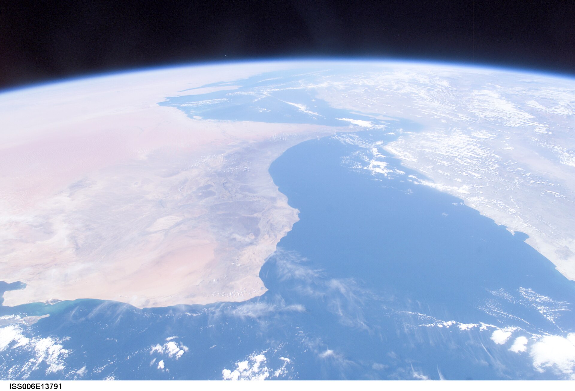 Gulf of Oman and the Arabian Peninsula photographed from ISS Expedition 6 — the narrow strait at top is the Strait of Hormuz, through which three Bahri VLCCs transited AIS-dark on June 18, 2026, carrying six million barrels of Saudi crude
