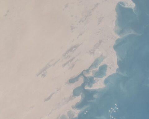 ISS Expedition 35 satellite view of Saudi Arabia Eastern Province coastline near Jubail and Ras Tanura, showing oil loading jetties extending into the Persian Gulf