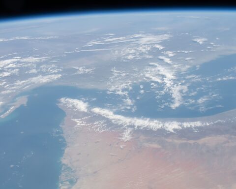 Strait of Hormuz, Dubai, and the Persian Gulf seen from the International Space Station during Expedition 62. The strait narrows to 21 miles at its chokepoint — the world's most critical oil shipping lane, closed to commercial traffic since conflict began in 2026.