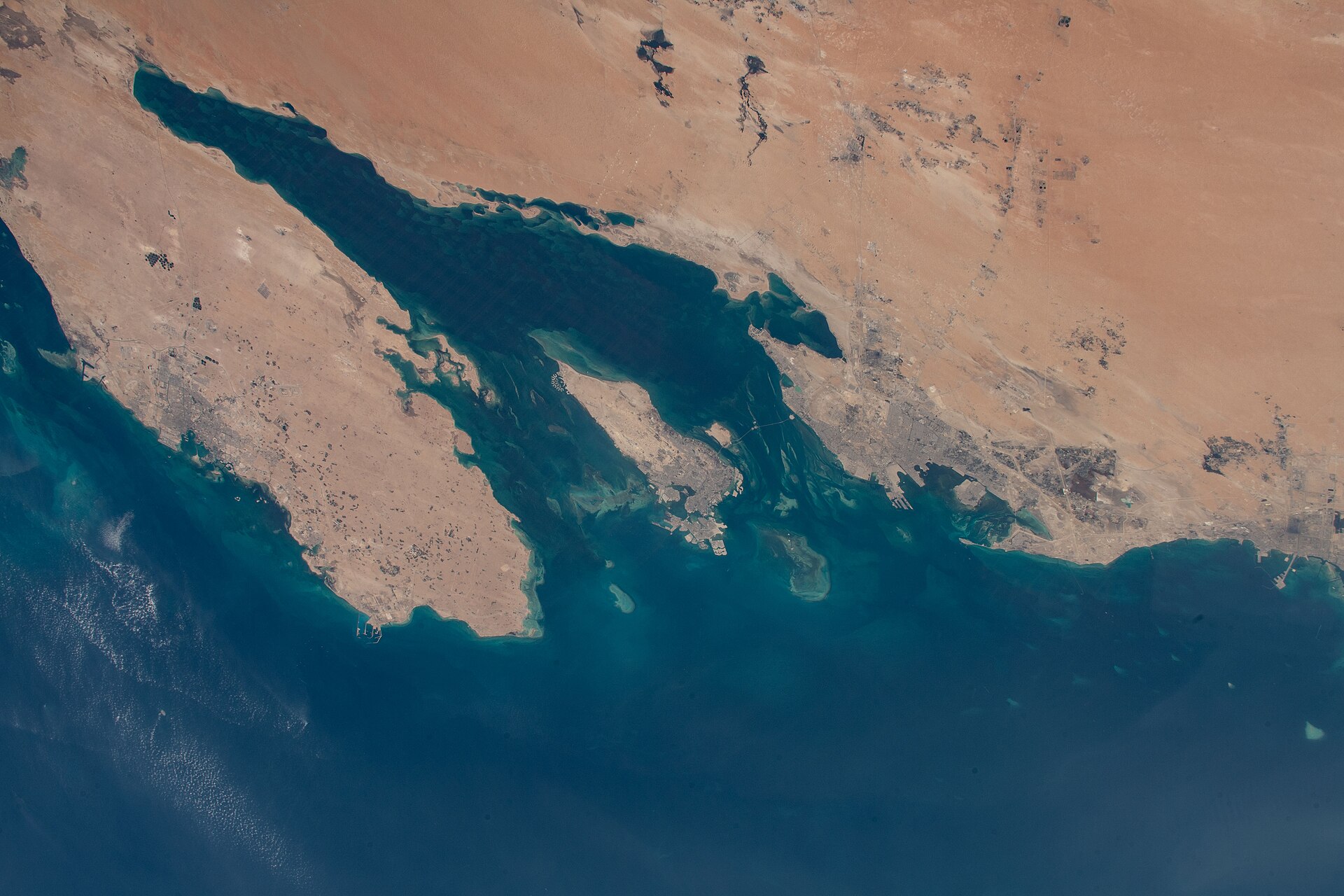 ISS Expedition 66 satellite view of the Qatar peninsula and Saudi Arabian Eastern Province on the Persian Gulf, where Saudi crude exports transit toward Hormuz
