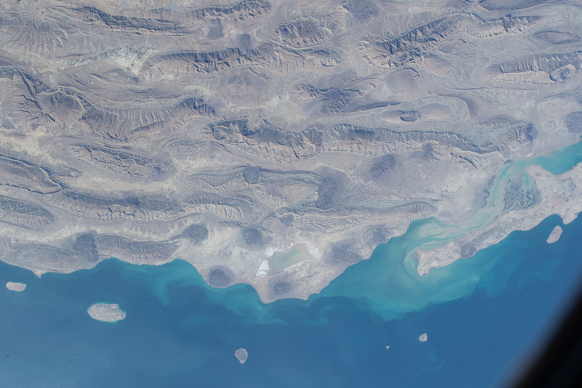 Iran southern coast and Persian Gulf from the International Space Station, ISS Expedition 66 — the rocky desert terrain of southern Iran meets the blue waters of the strait controlled by the PGSA