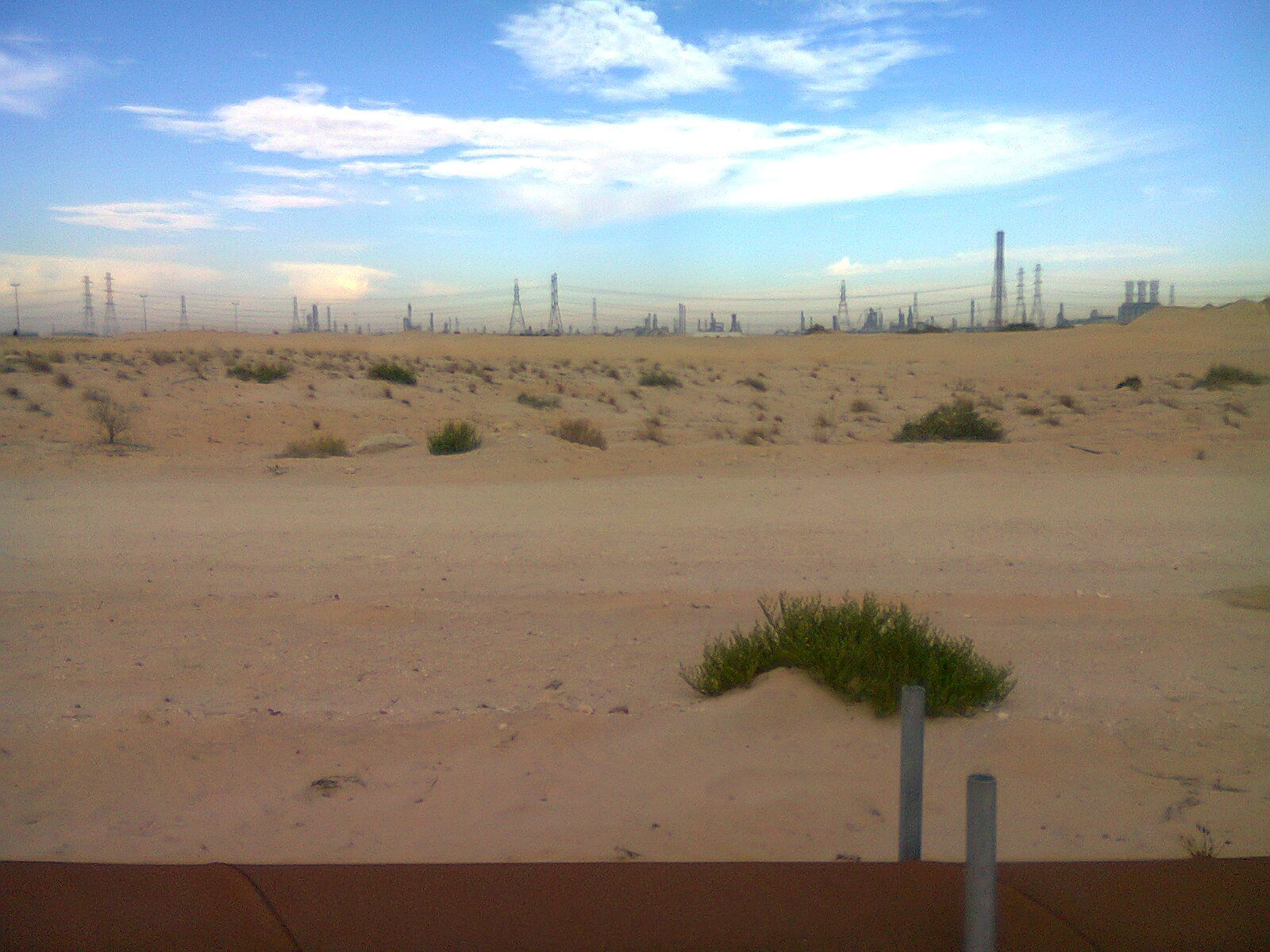 The Satorp refinery complex at Jubail Industrial City, Saudi Arabia, photographed from the road — one of dozens of petrochemical facilities that make up the Eastern Province corridor representing approximately 7 percent of Saudi GDP.