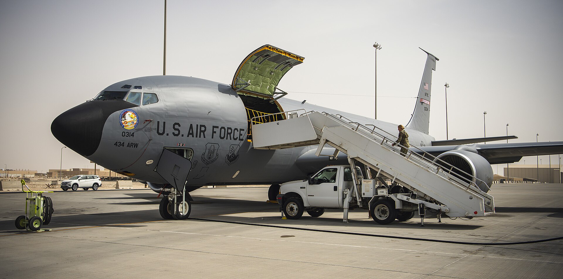 KC-135 Stratotanker on the flightline at Al Udeid Air Base, Qatar — base housing CENTCOM forward headquarters and the reported IRGC deconfliction cell
