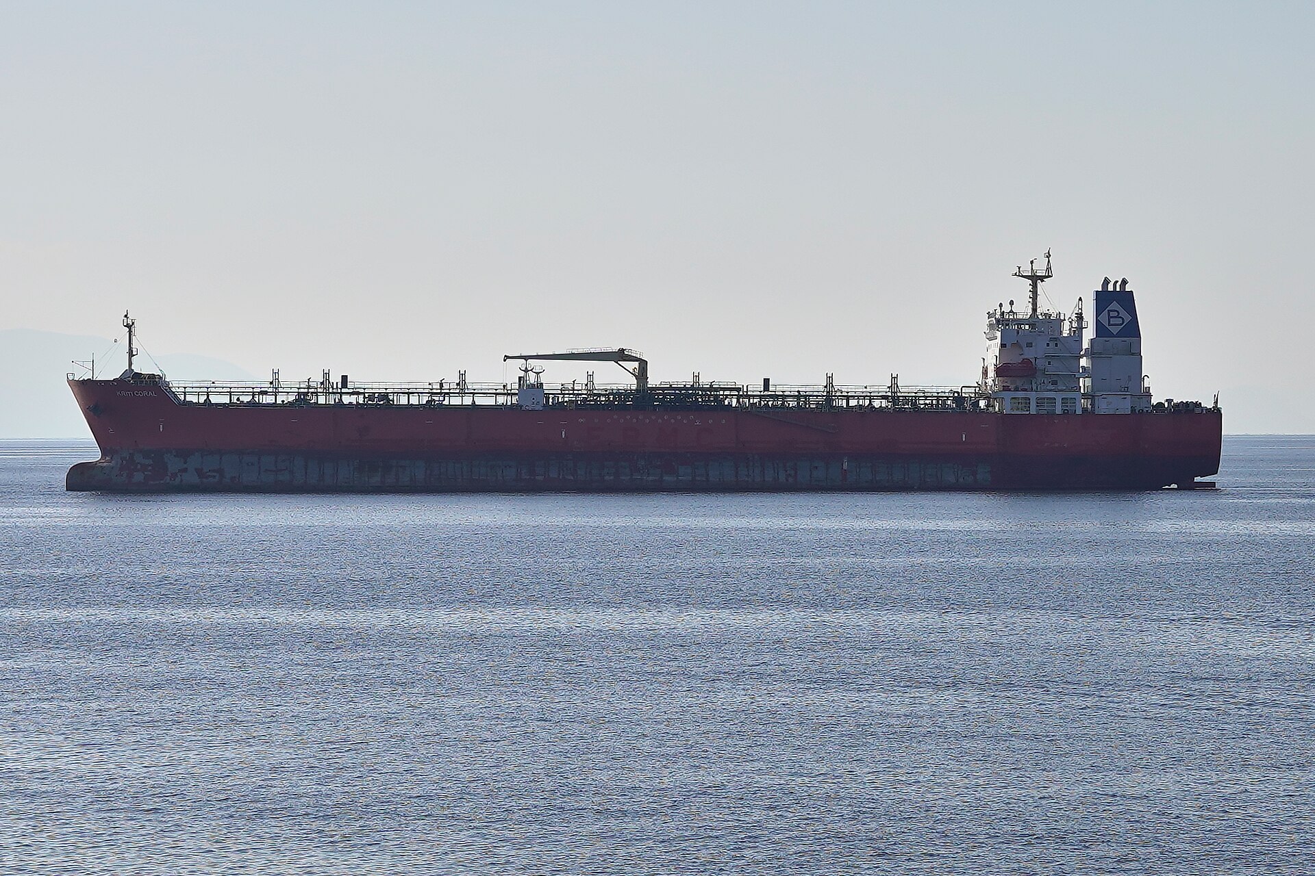 Crude oil tanker Kriti Coral underway at sea, viewed from sea level — a large VLCC-class vessel whose scale illustrates the commercial stakes of the Hormuz insurance gap