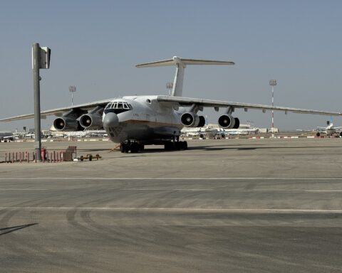Kuwait International Airport tarmac apron with aircraft, terminal building visible in background
