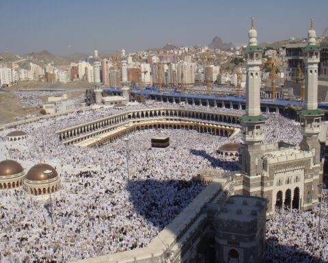 Aerial view of the Kaaba at Masjid al-Haram, Mecca, during Hajj, with tens of thousands of pilgrims in white ihram circling the Grand Mosque