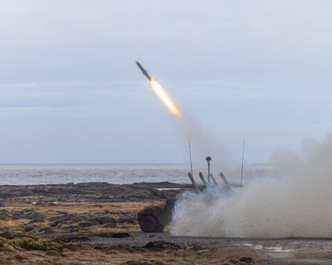 Norwegian Army NASAMS launcher fires an interceptor missile during Exercise Formidable Shield 2023 — the same National Advanced Surface-to-Air Missile System Kuwait purchased in a $1.02B Raytheon contract on May 26, 2026