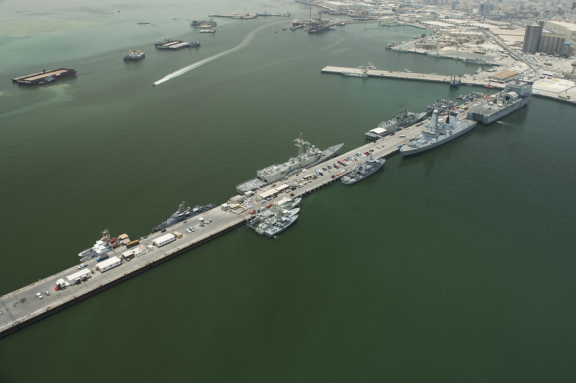 Aerial view of US Navy warships moored at Naval Support Activity Bahrain (Mina Salman) in Manama, Bahrain, May 2013. NSA Bahrain is home to US Naval Forces Central Command and the Fifth Fleet, approximately 25 kilometers from Saudi Arabia's Eastern Province.