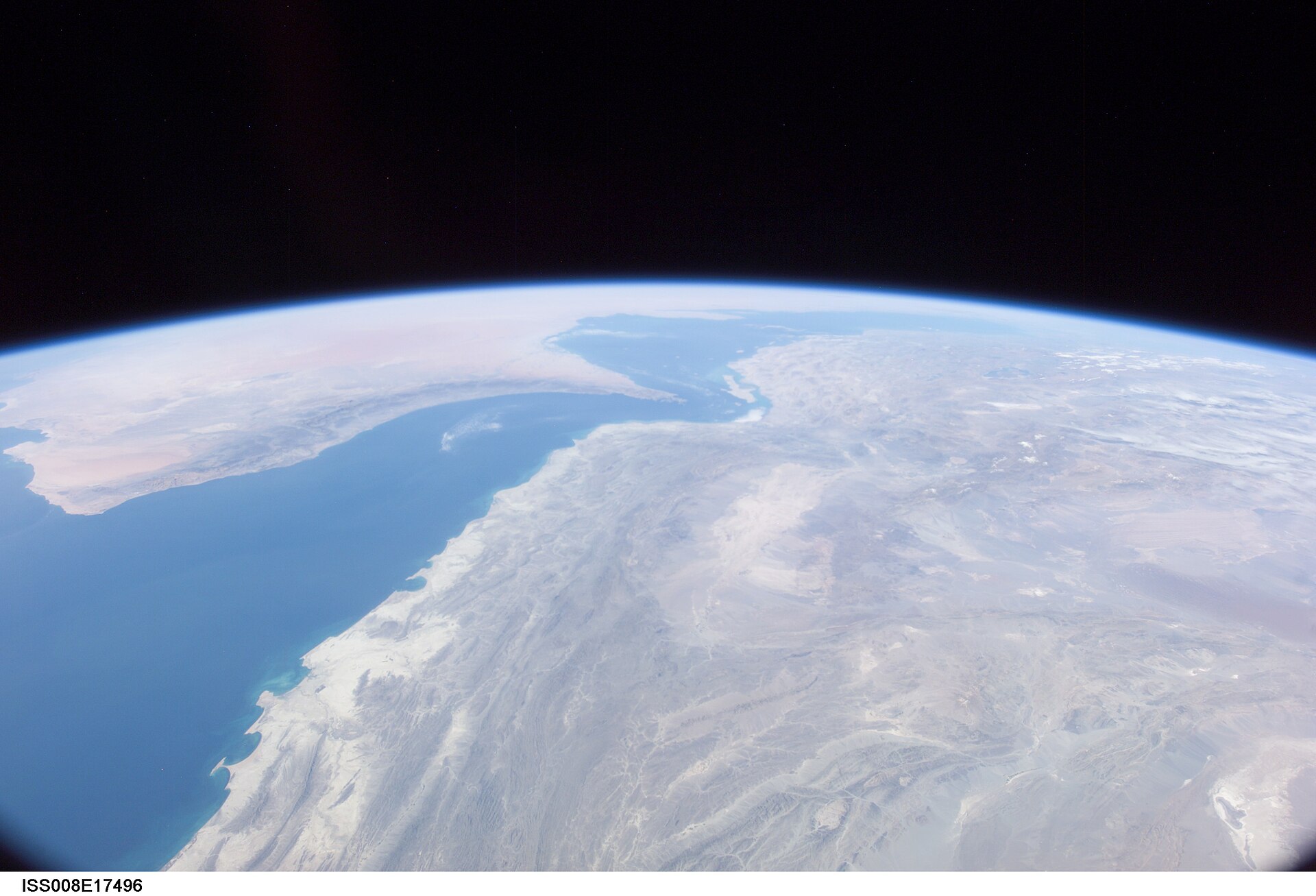 Persian Gulf and Strait of Hormuz photographed from the International Space Station, showing the narrowing waterway between Iran and the Arabian Peninsula where Iran imposed service fees in May 2026