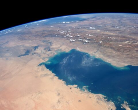 The Persian Gulf photographed from the International Space Station during Expedition 40, showing the full extent of the waterway where approximately 600 vessels were waiting as of June 15, 2026. The Strait of Hormuz narrows to 21 miles at the right of the image. Photo: NASA / Public Domain