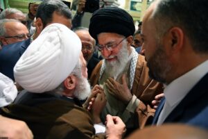 Hezbollah Secretary-General Naim Qassem (white turban) greets then-Supreme Leader Ali Khamenei at the 31st International Islamic Unity Conference, Tehran 2017 — the structural Hezbollah-Iran relationship that made his June 4 ceasefire rejection operationally significant
