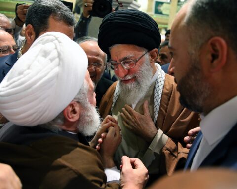 Hezbollah Secretary-General Naim Qassem (white turban) greets then-Supreme Leader Ali Khamenei at the 31st International Islamic Unity Conference, Tehran 2017 — the structural Hezbollah-Iran relationship that made his June 4 ceasefire rejection operationally significant
