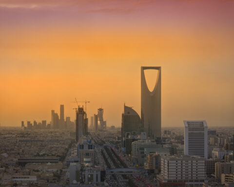 Riyadh skyline at sunset showing the King Abdullah Financial District KAFD and Kingdom Tower under construction — PIF headquarters city
