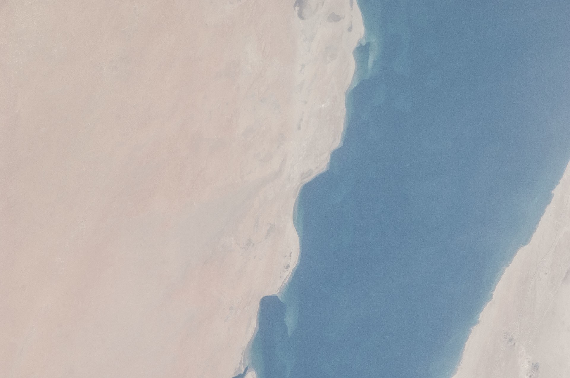 Saudi Arabia Eastern Province coastline on the Persian Gulf photographed from the International Space Station — the oil-bearing territory that has defined Saudi export capacity since the 1938 Dammam No. 7 discovery