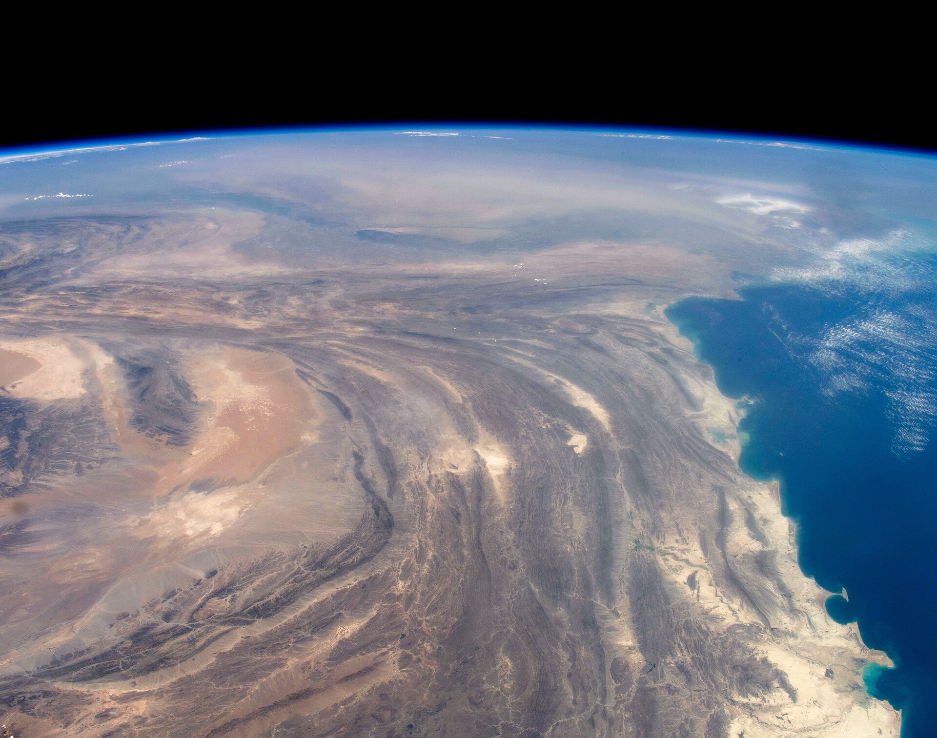 Saudi Arabia and the Persian Gulf coastline photographed from the International Space Station in May 2026, showing the Eastern Province industrial coast and Gulf shipping lanes during the Hormuz crisis