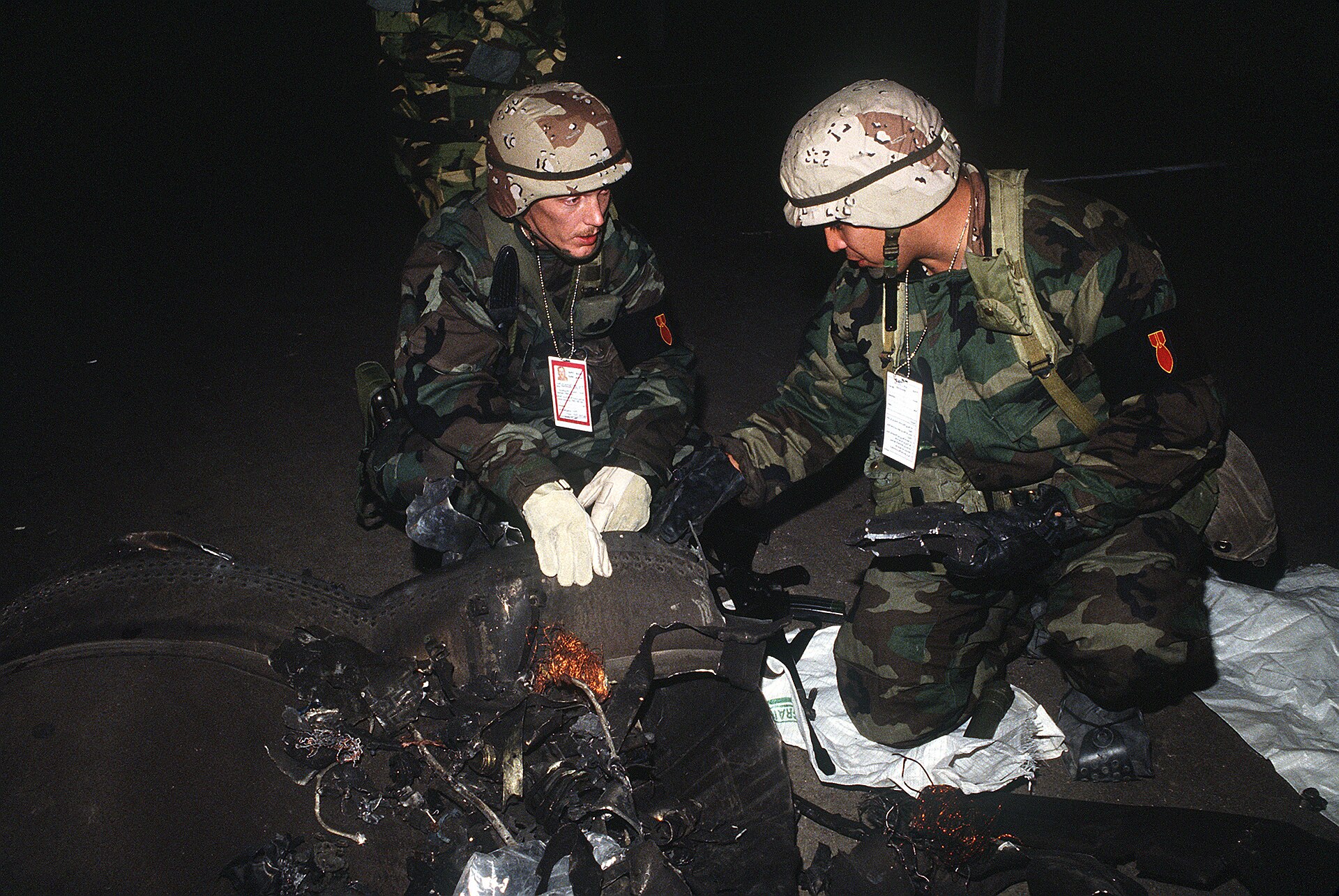US explosive ordnance disposal technicians inspect the wreckage of an Iraqi Scud missile shot down by a Patriot interceptor during Operation Desert Storm in Saudi Arabia