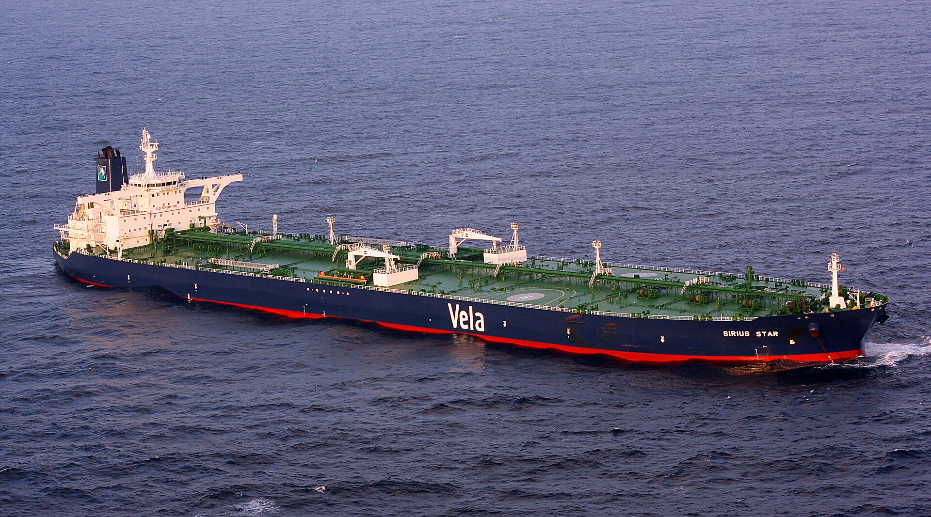 MV Sirius Star, a Saudi Aramco-owned VLCC (Very Large Crude Carrier) operated by Vela International Marine, at anchor off Somalia in 2008. Saudi crude exports require Hormuz transit — at $90 a barrel, every dollar below the $108-111 fiscal breakeven costs Riyadh approximately $162-189 million per day.