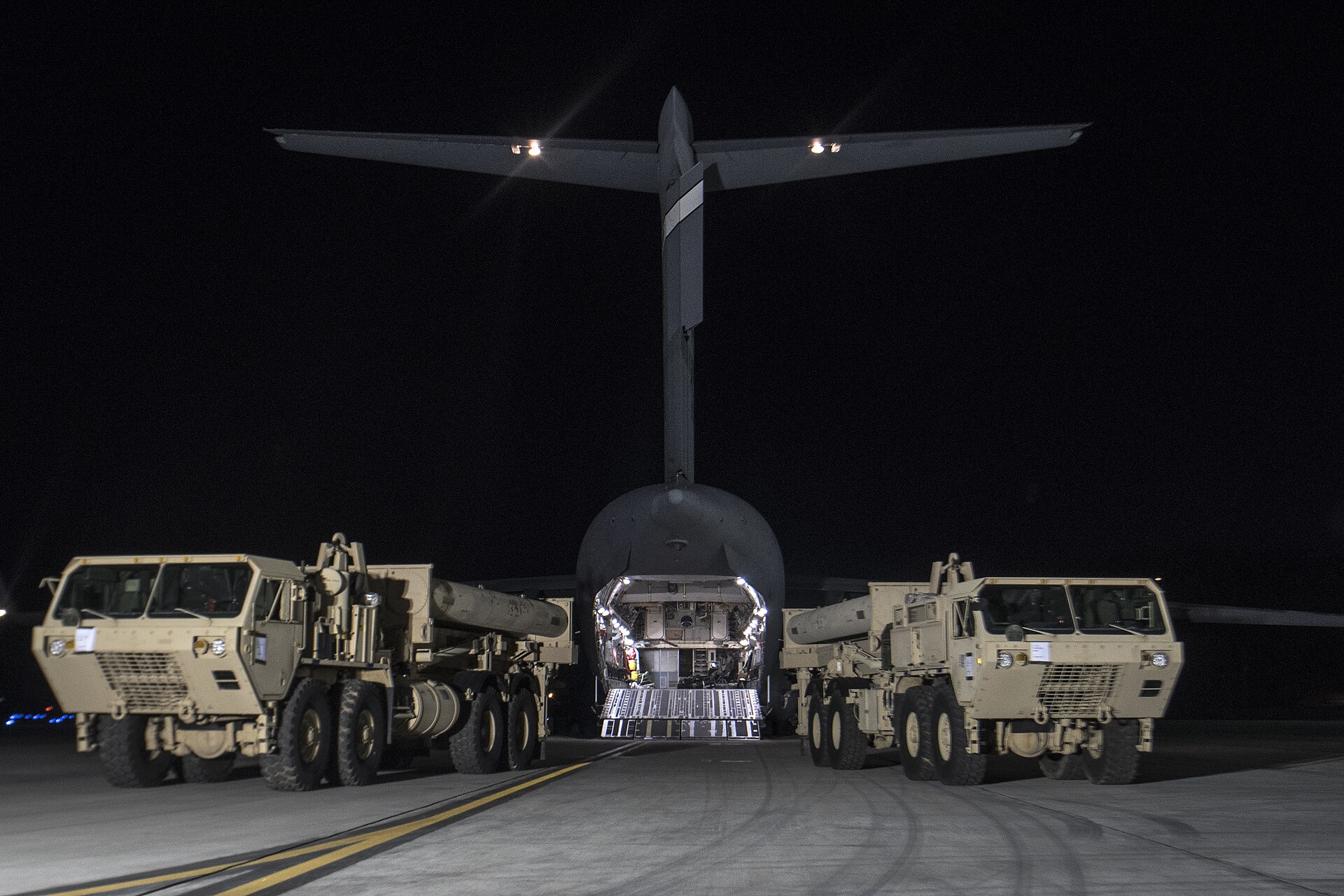 Two US Army THAAD launcher vehicles unloaded from a C-17 transport aircraft during deployment to South Korea, March 2017
