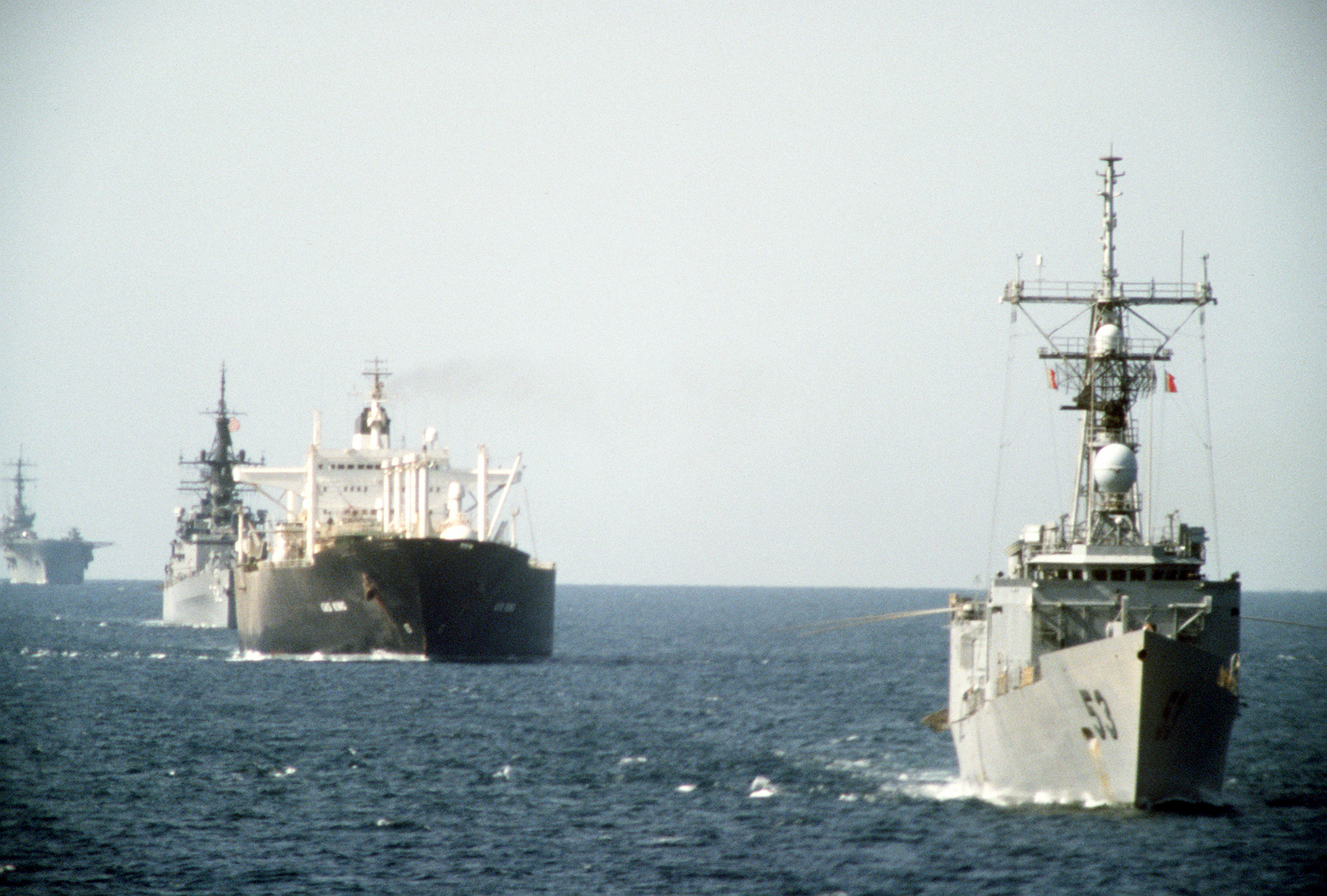 USS Hawes (FFG-53) escorts reflagged Kuwaiti tanker Gas King through the Persian Gulf alongside USS William H. Standley and USS Guadalcanal during Operation Earnest Will, October 1987