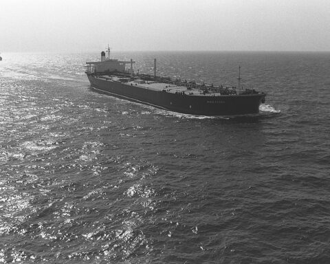 Oil tanker SS Middleton underway in the Persian Gulf with US Navy escort vessels visible on the horizon during Operation Earnest Will convoy mission, 1988