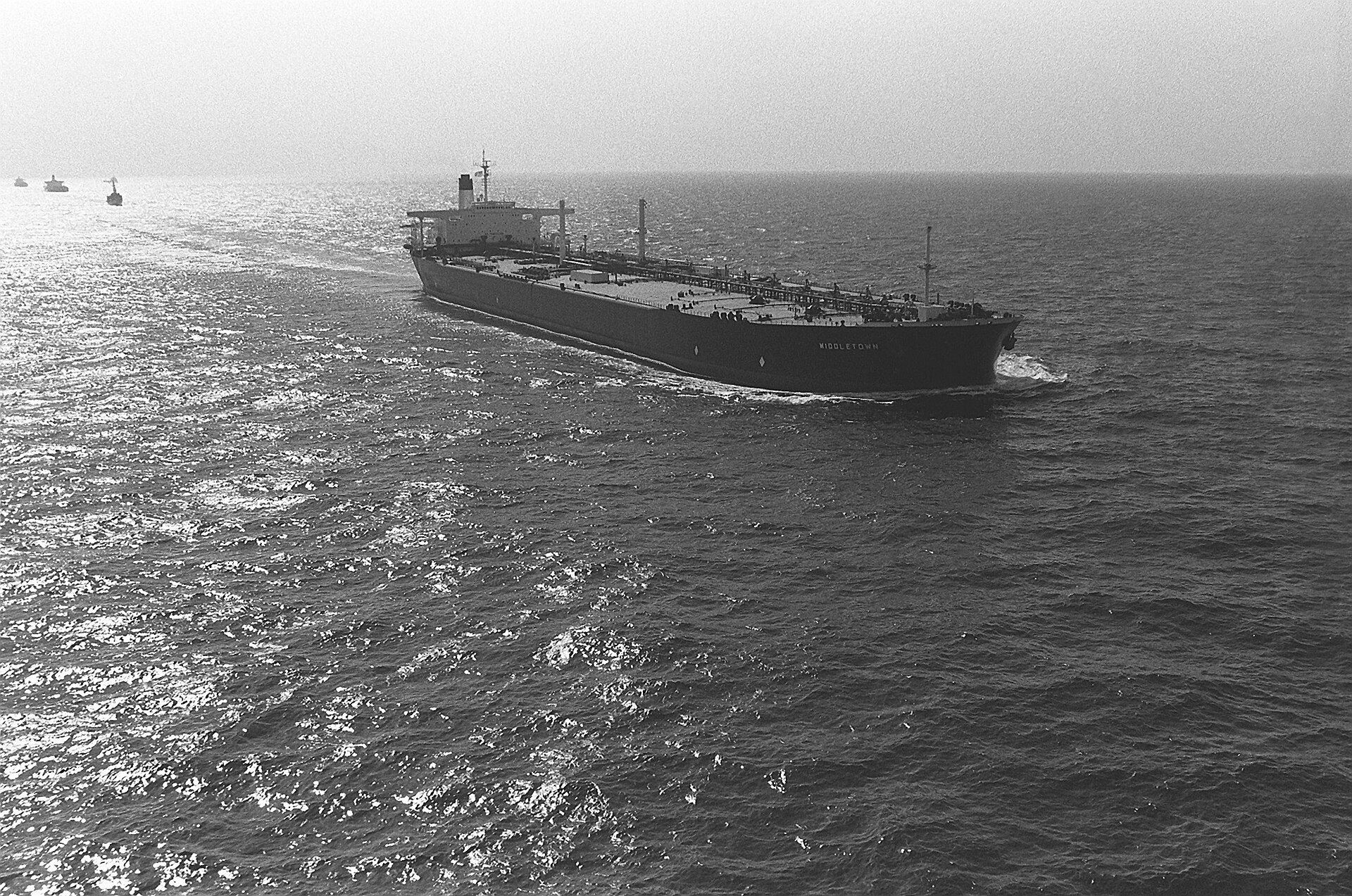 Oil tanker SS Middleton underway in the Persian Gulf with US Navy escort vessels visible on the horizon during Operation Earnest Will convoy mission, 1988