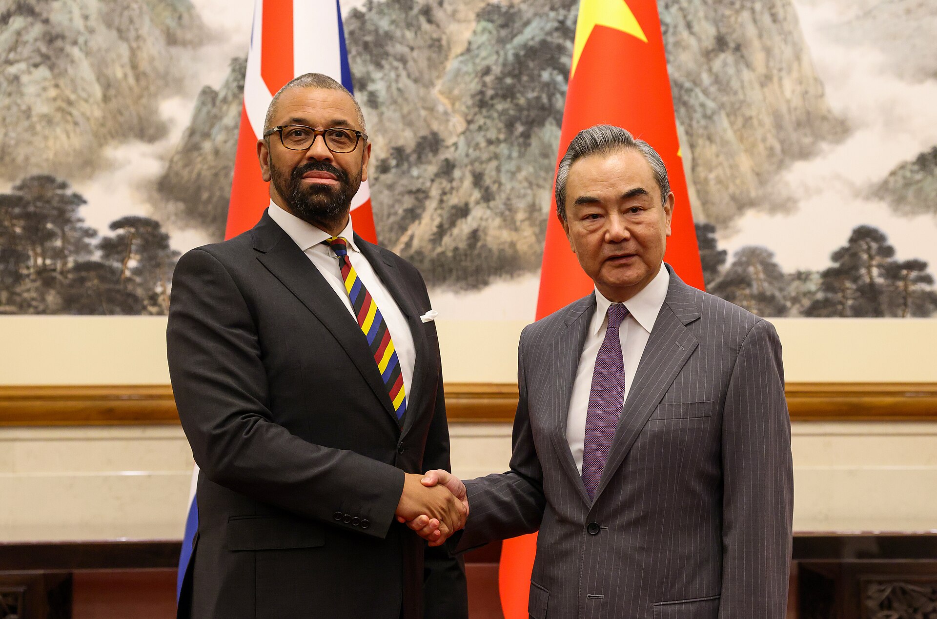 Chinese Foreign Minister Wang Yi shakes hands with UK Foreign Secretary James Cleverly at the State Guest House in Beijing, 2023 — the same venue where Wang Yi hosts bilateral meetings with Gulf state counterparts